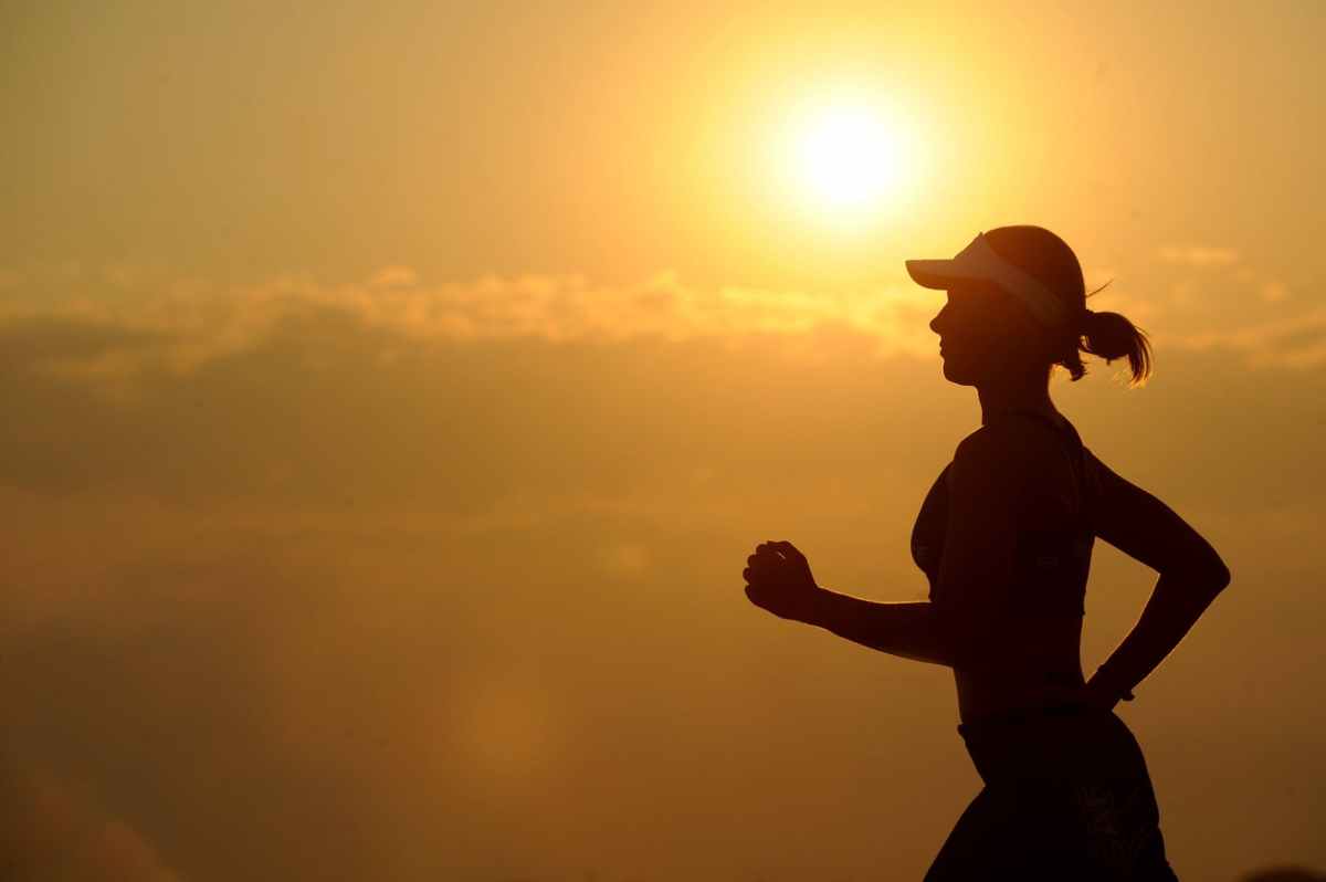 Woman running at sunrise: endurance