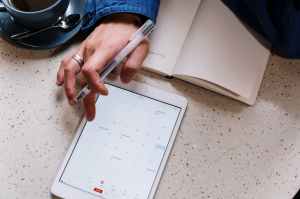 Electronic calendar displayed on a tablet: Slow Living - 7 Ways to Elevate Focus Over Frenzy